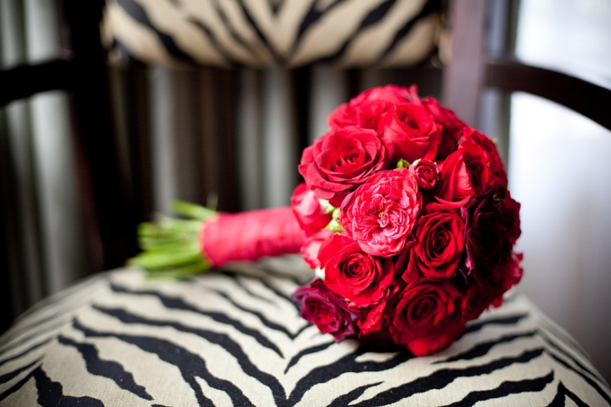 Red Bridal bouquet on a leopard print chair in hotel bridal suite by dc