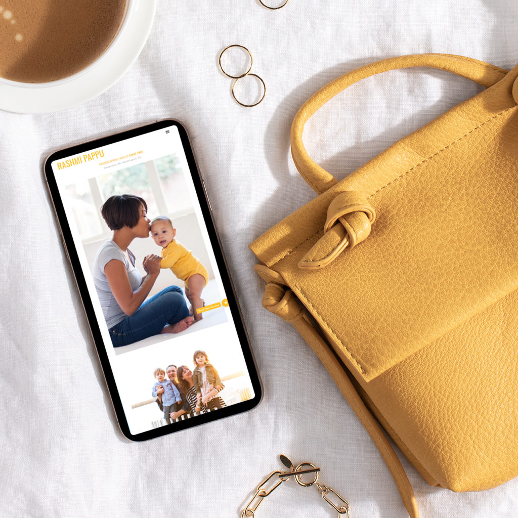 photography mobile website shown on phone alongside yellow purse