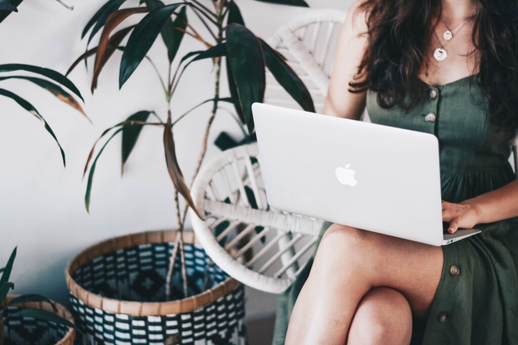 website design for creative women, woman working on laptop in green dress