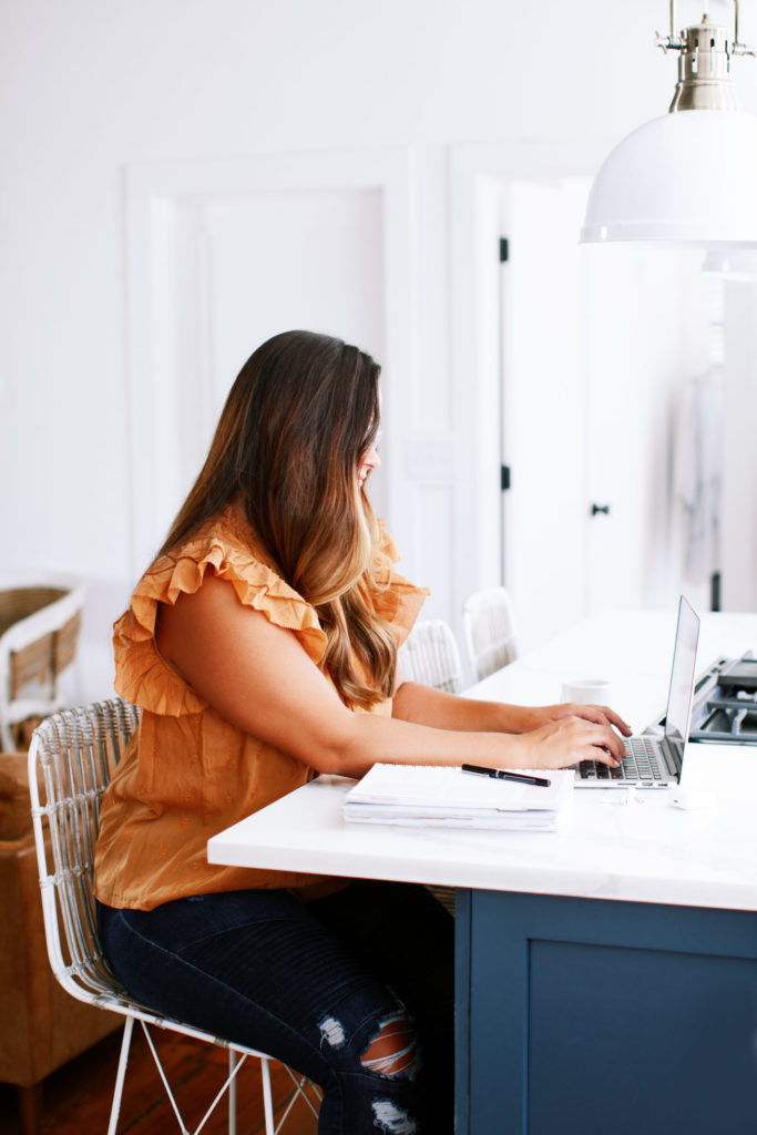 Photographer looking at web designers for photographers - woman at laptop 