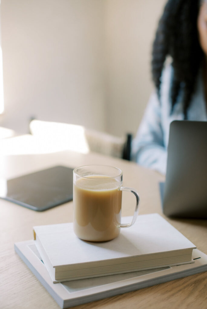 Woman working at laptop with coffee